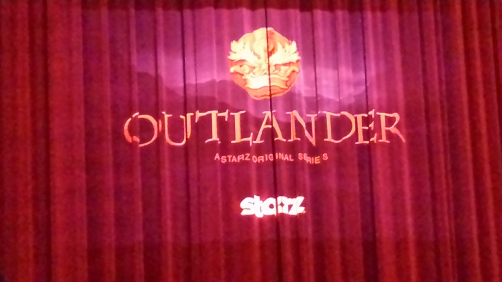 Image of a red curtain with the word Outlander on it.