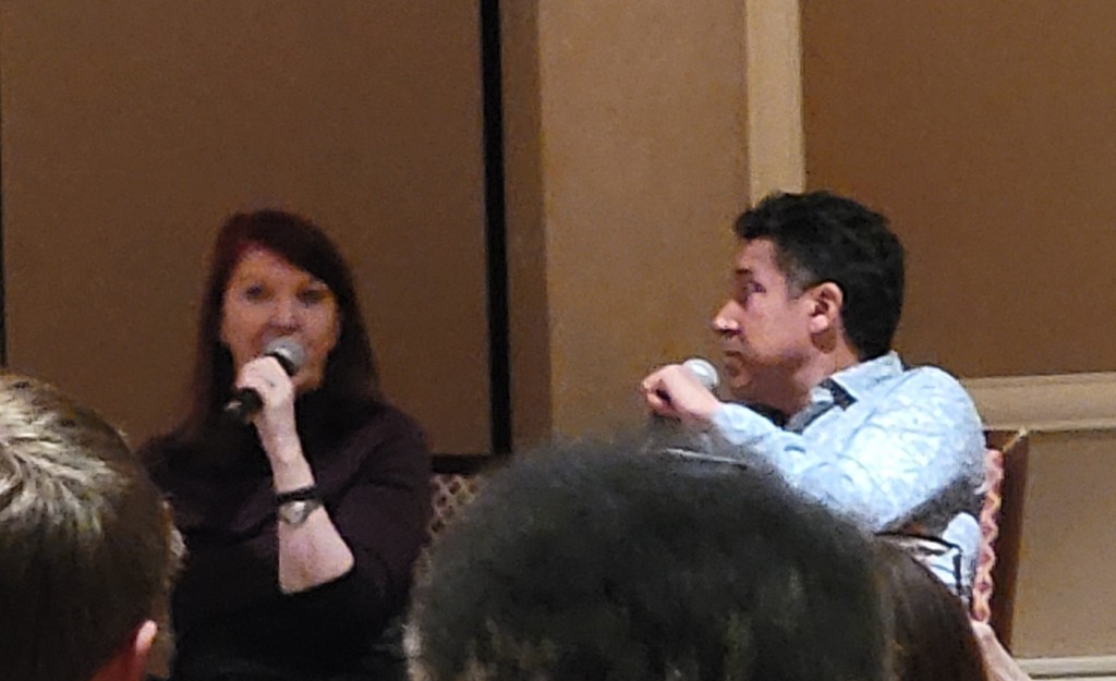 Kate Flannery and Oscar Nunez speaking in front of a crowd